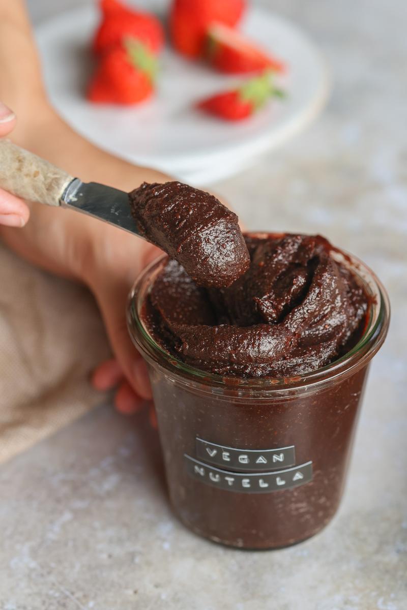 taking a spoonful of vegan chocolate nut spread