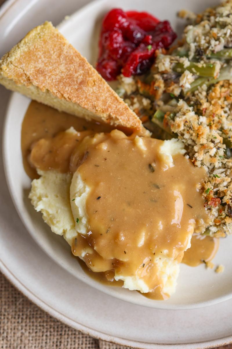 a plate of plant based christmas dinner featuring an easy thanksgiving sauce