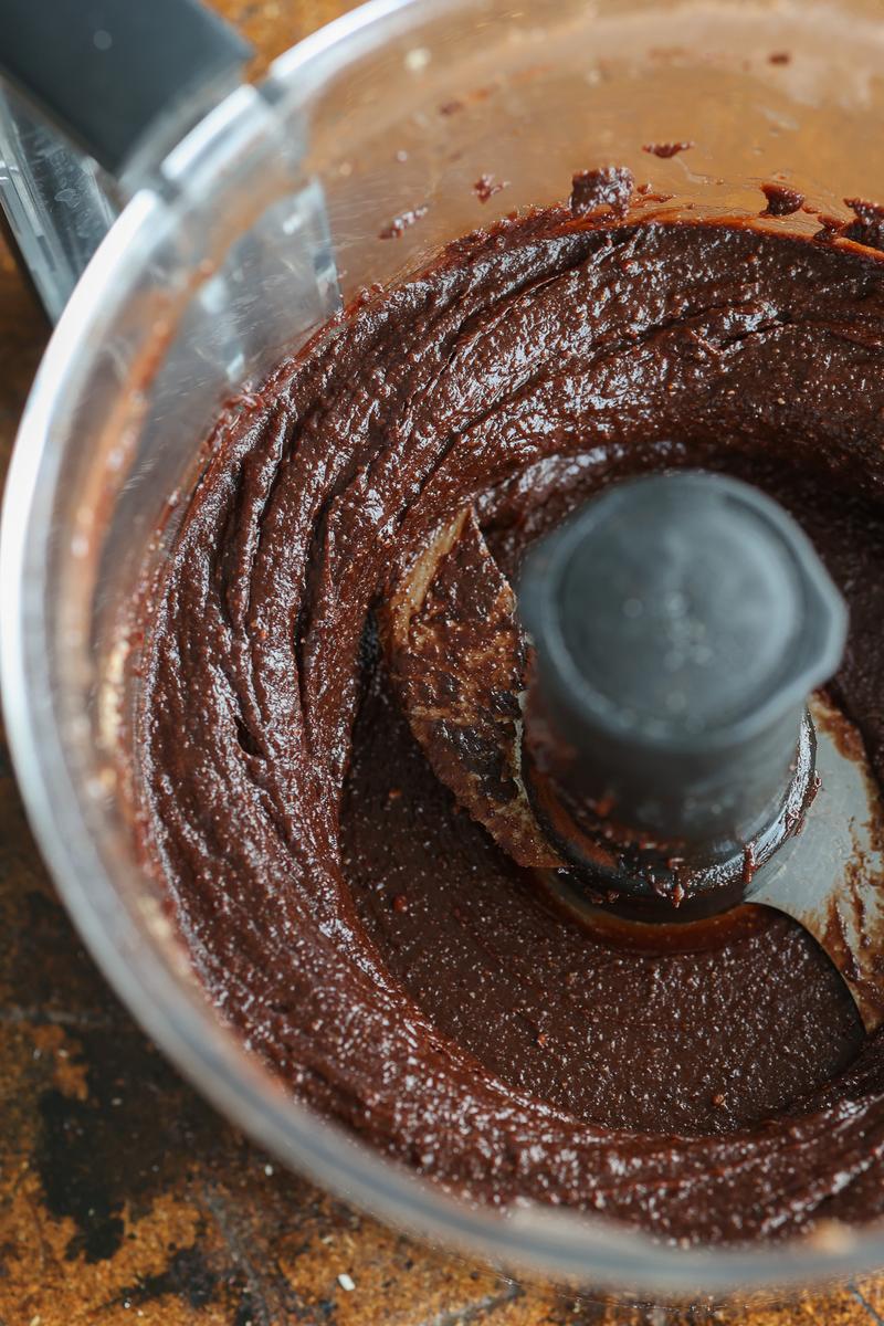 blending roasted hazelnuts, coco powder, and dates into homemade vegan chocolate spread