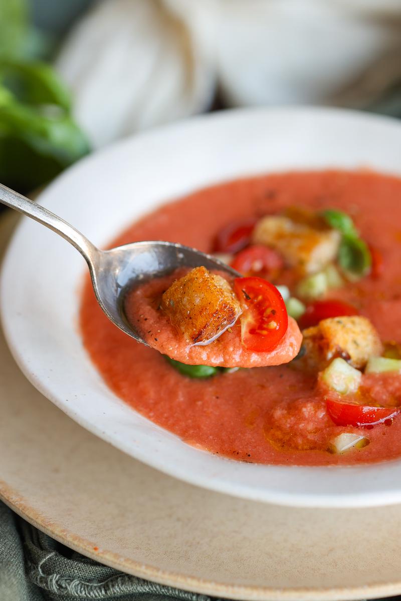 a vegetarian taking a spoonful of the easy summer soup recipe