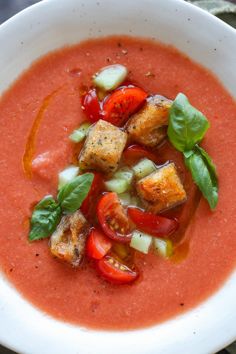 a bowl of chilled soup with tomatoes